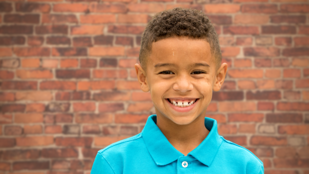 kid smiling in polo shirt