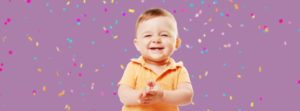 baby smiling with confetti baby oral health exam
