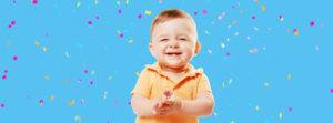 baby smiling with confetti baby oral health exam