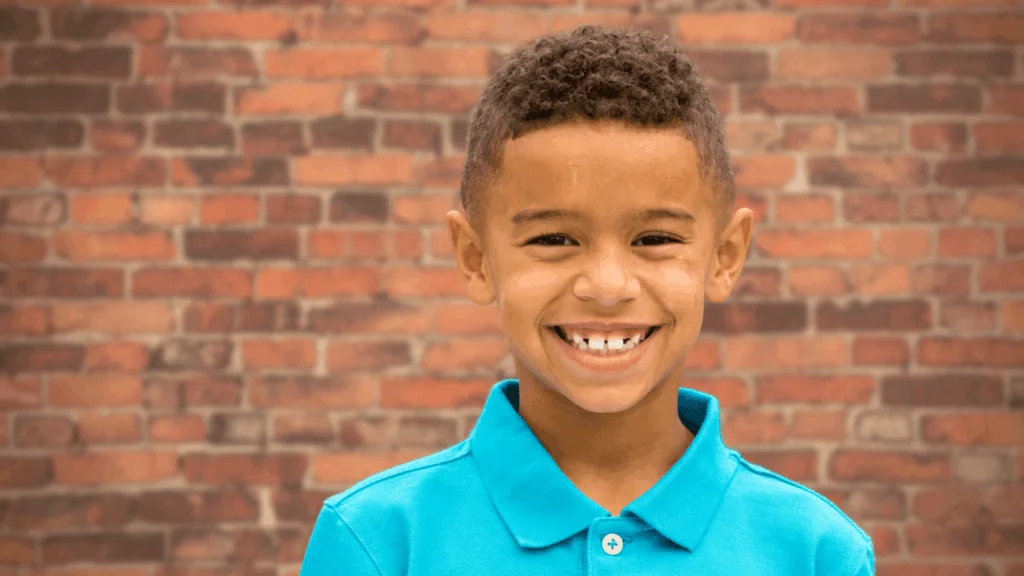 kid smiling in polo shirt